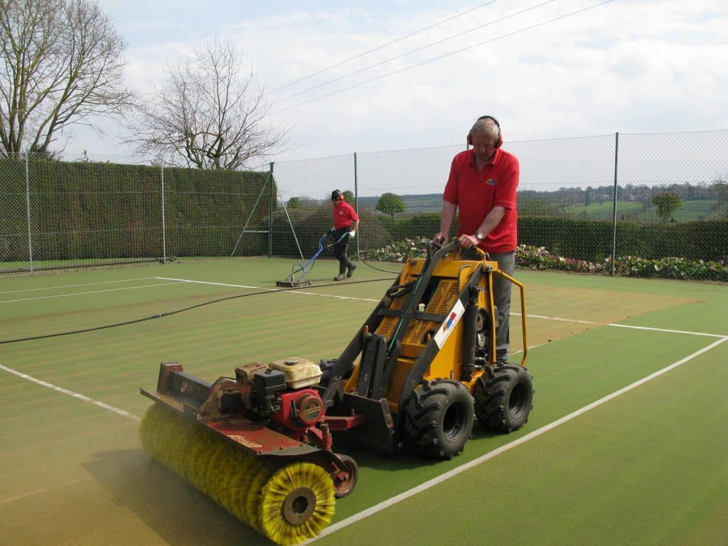 Cleaning a tennis court carpet