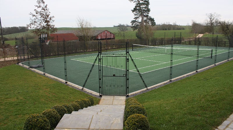 A hard tennis court built by En Tout Cas, with patented obelisk fencing